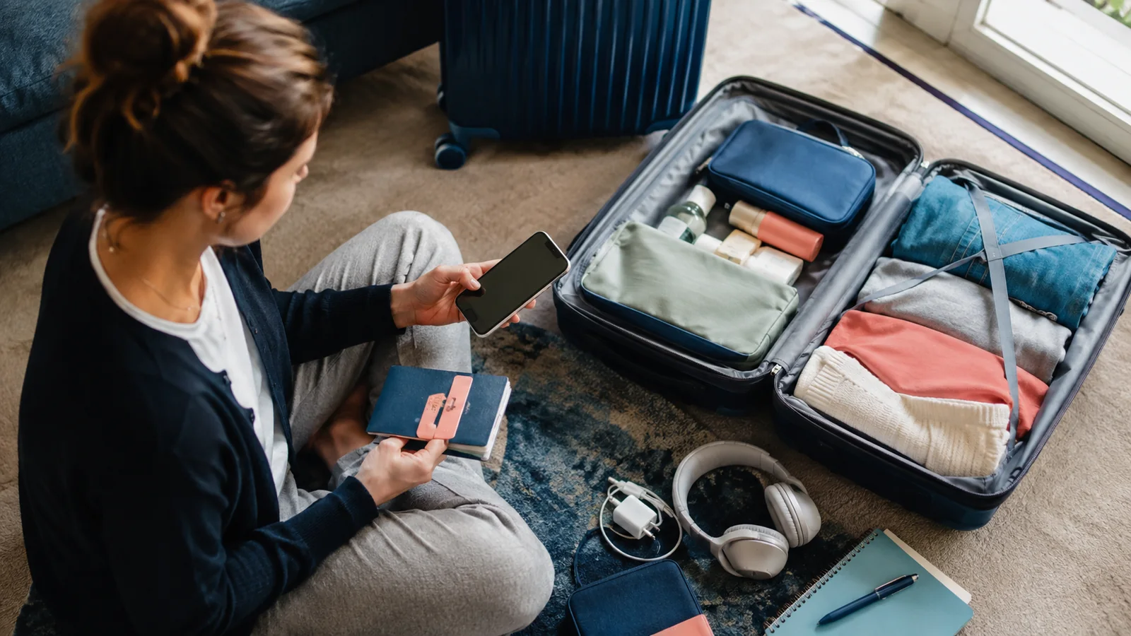 Traveller preparing practical essentials for a trip